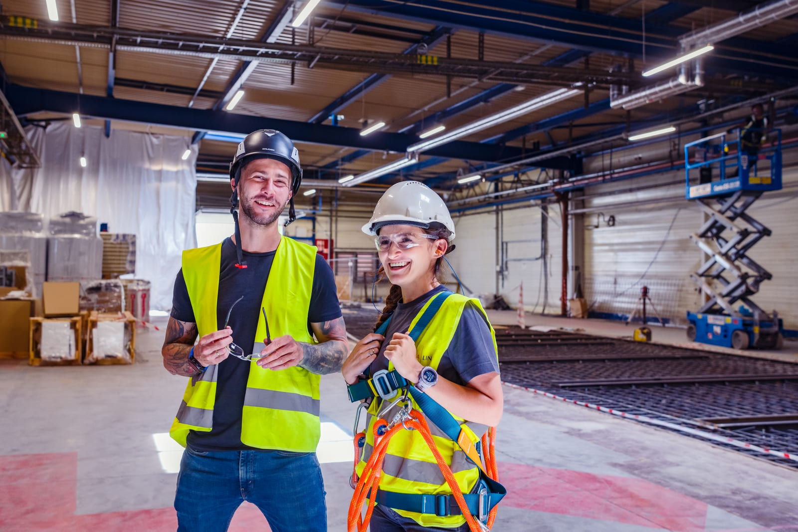 Clima Line co-owners in helmets and harnesses in the hall during cleanroom construction